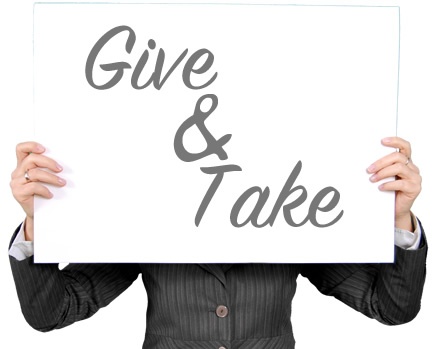 person holding sign that says give and take regarding business growth