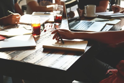 image of people working at a table talking about marketing strategy